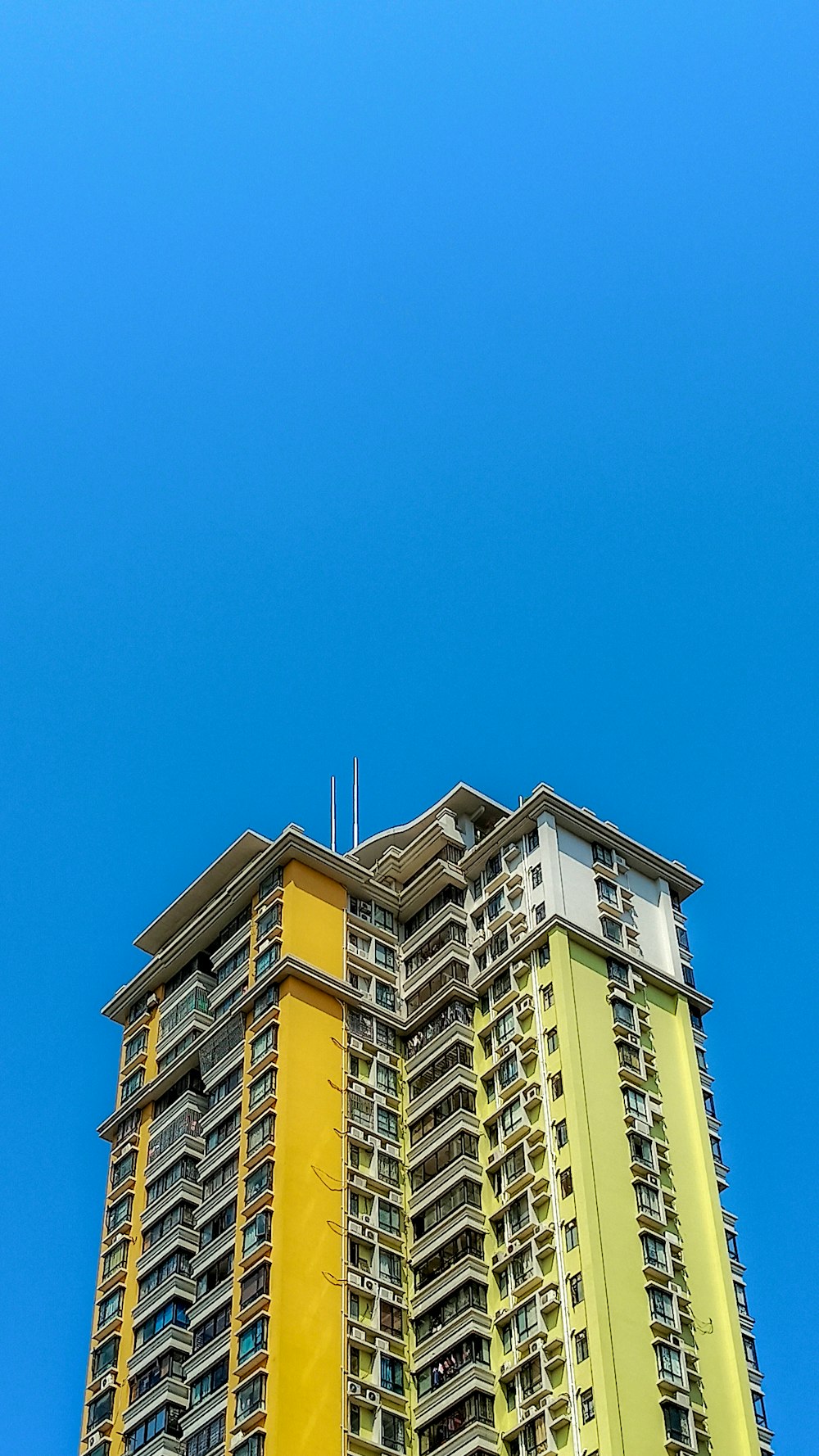 yellow and white concrete building under blue sky during daytime