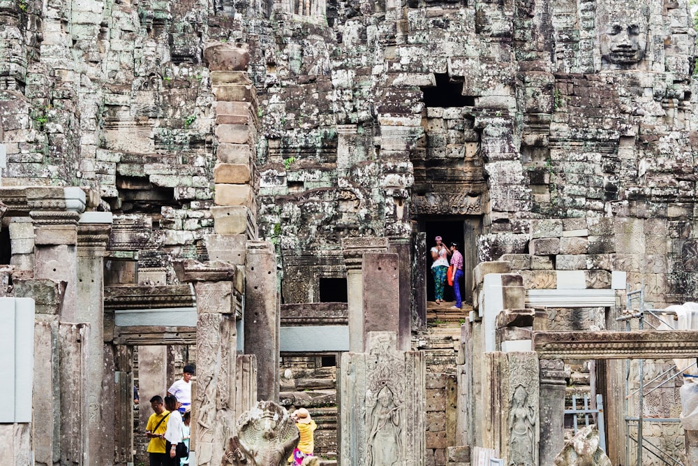 people standing near brown concrete building during daytime