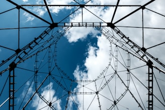 low angle photography of black metal frame under blue sky during daytime