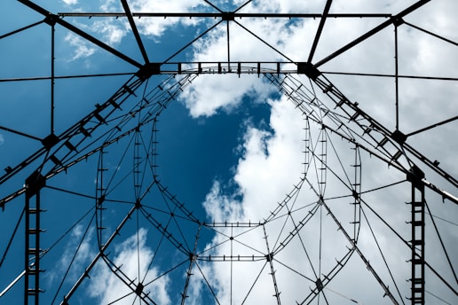 low angle photography of black metal frame under blue sky during daytime