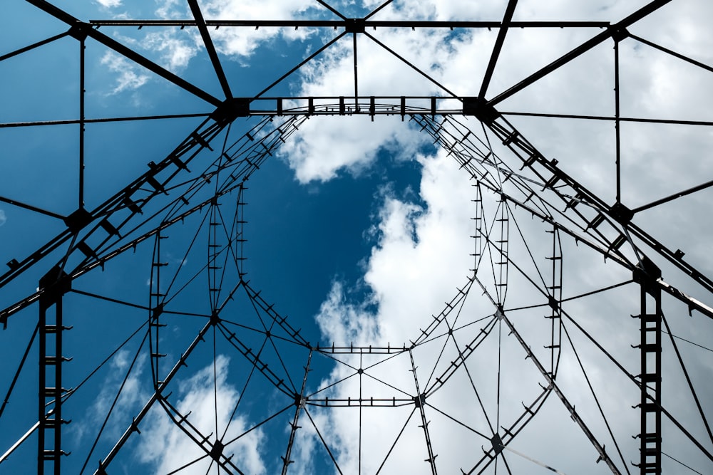 low angle photography of black metal frame under blue sky during daytime