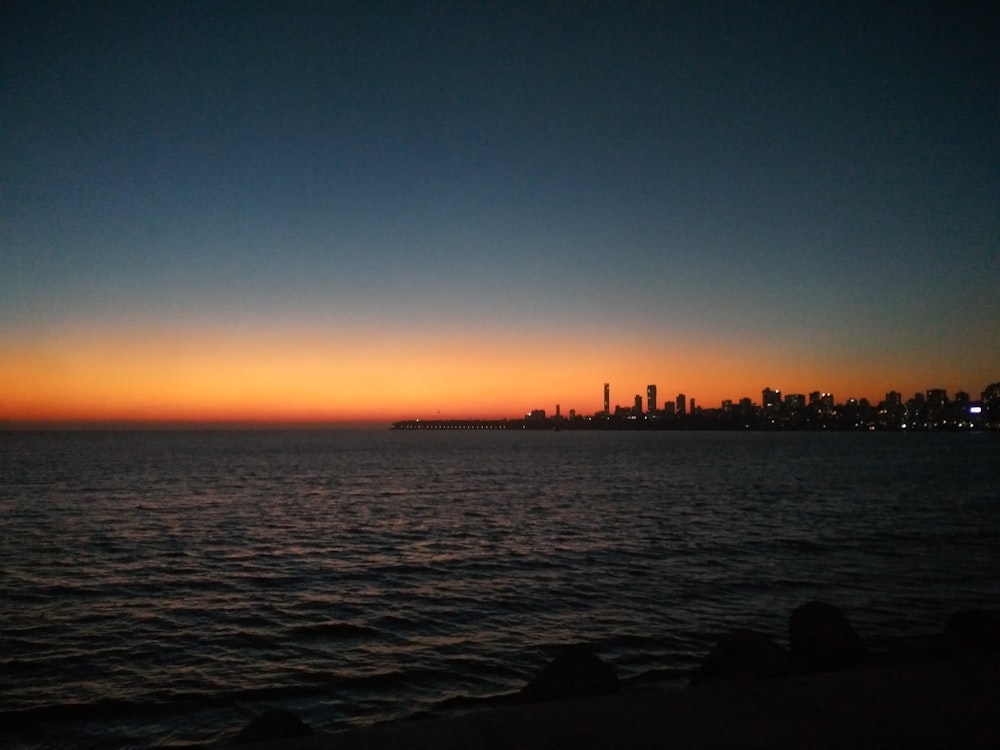 silhouette of people on beach during sunset