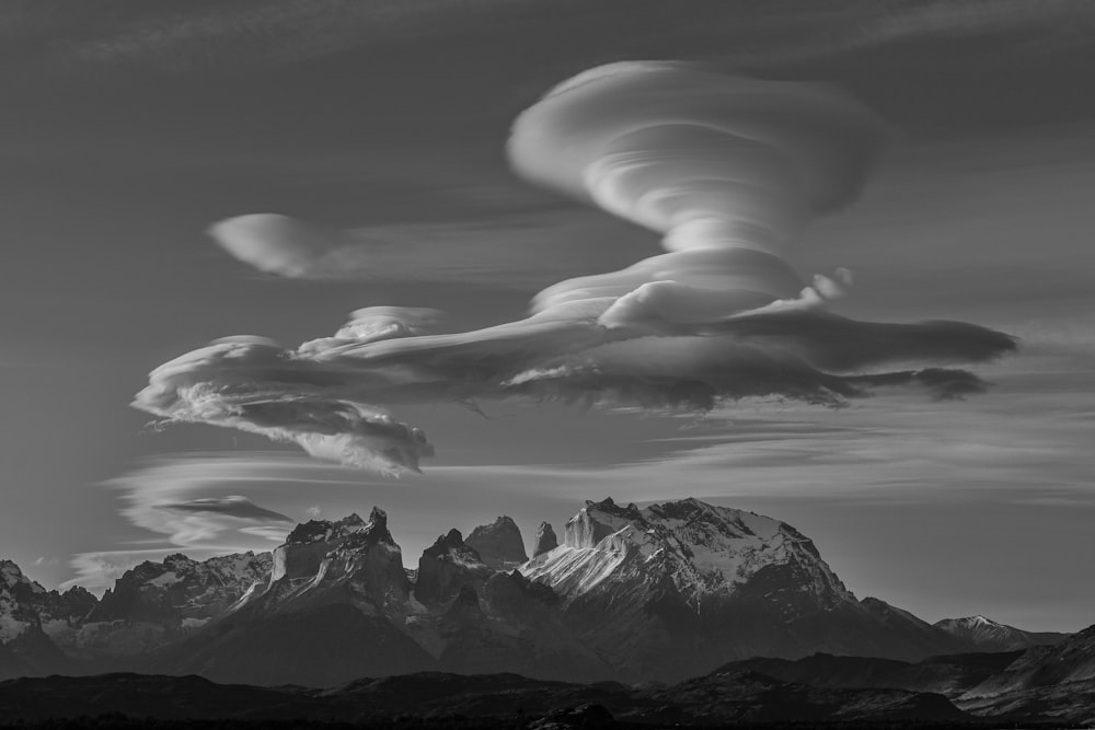 grayscale photo of mountains and clouds