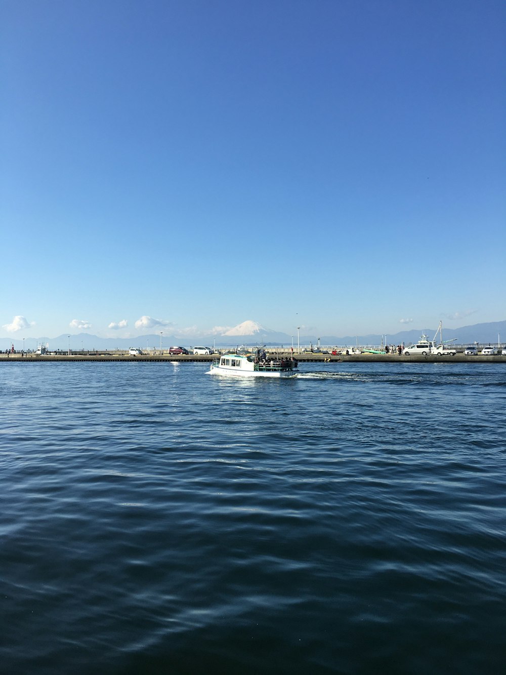 white boat on sea under blue sky during daytime