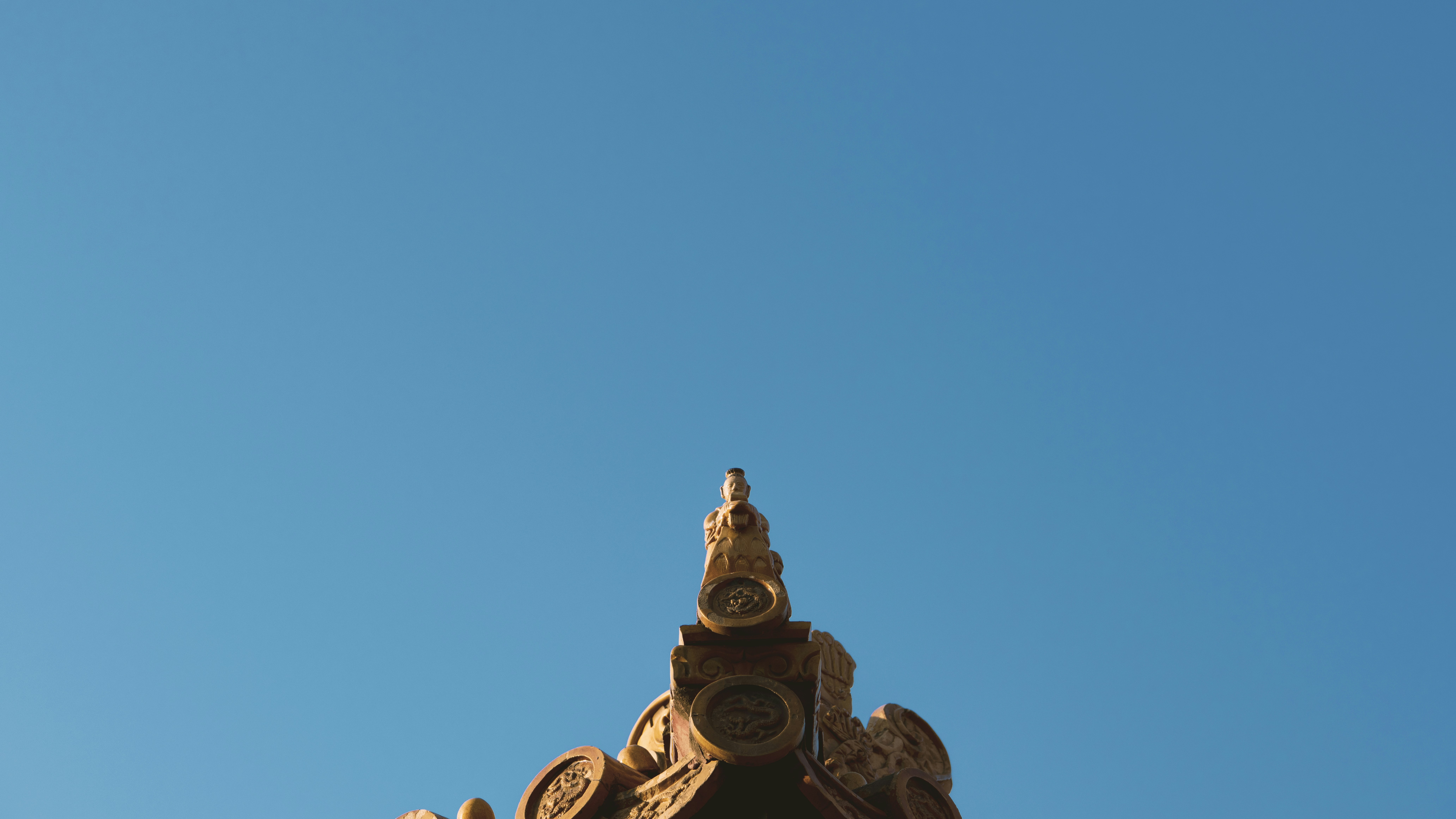 Statue d’or sous le ciel bleu pendant la journée