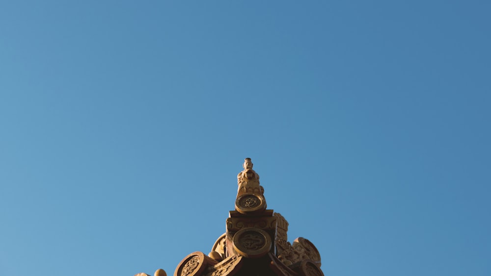 gold statue under blue sky during daytime