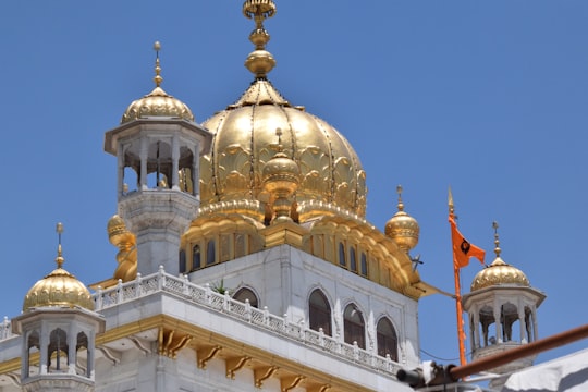 white and gold dome building in Harmandir Sahib India
