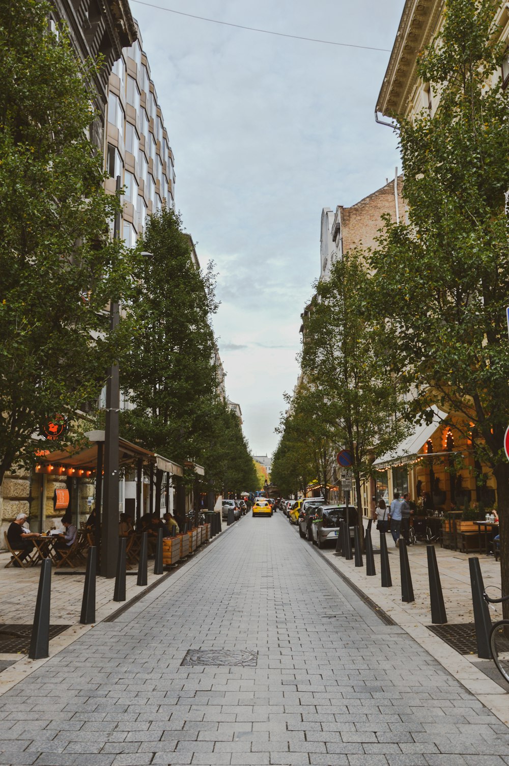 people walking on sidewalk near buildings during daytime