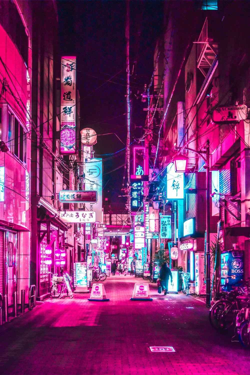 cars parked on street in between buildings during night time