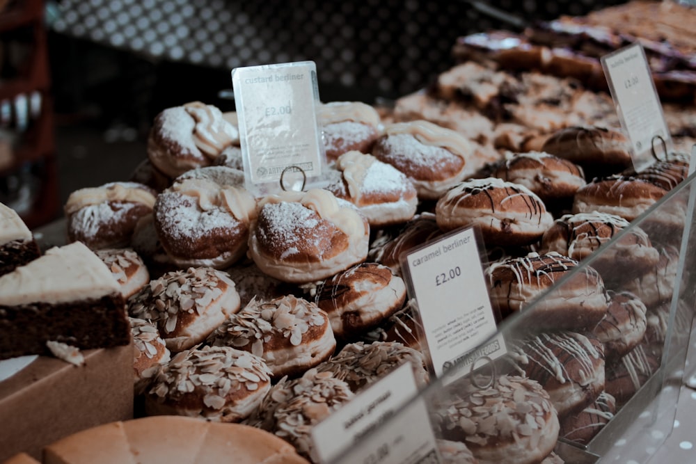 brown and white doughnuts on black metal rack