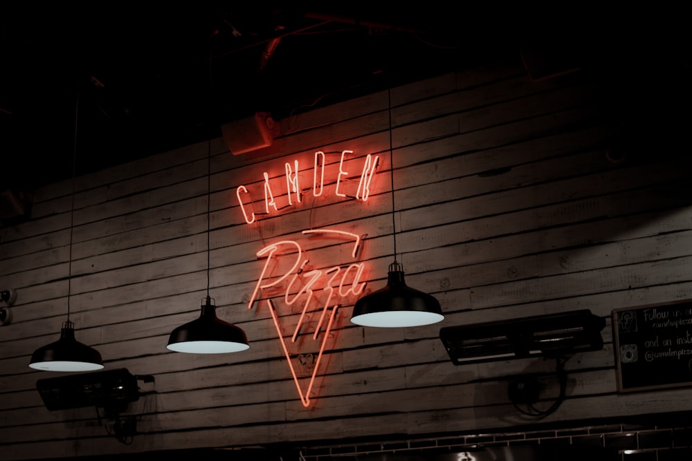 a neon sign on the wall of a restaurant