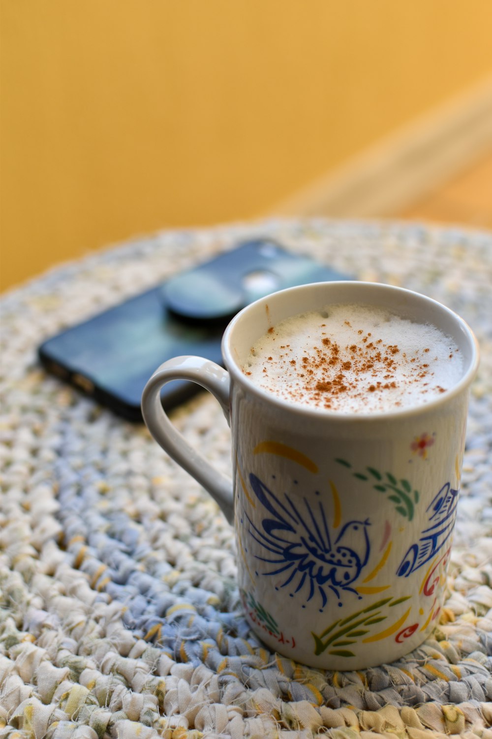 white and green ceramic mug with coffee