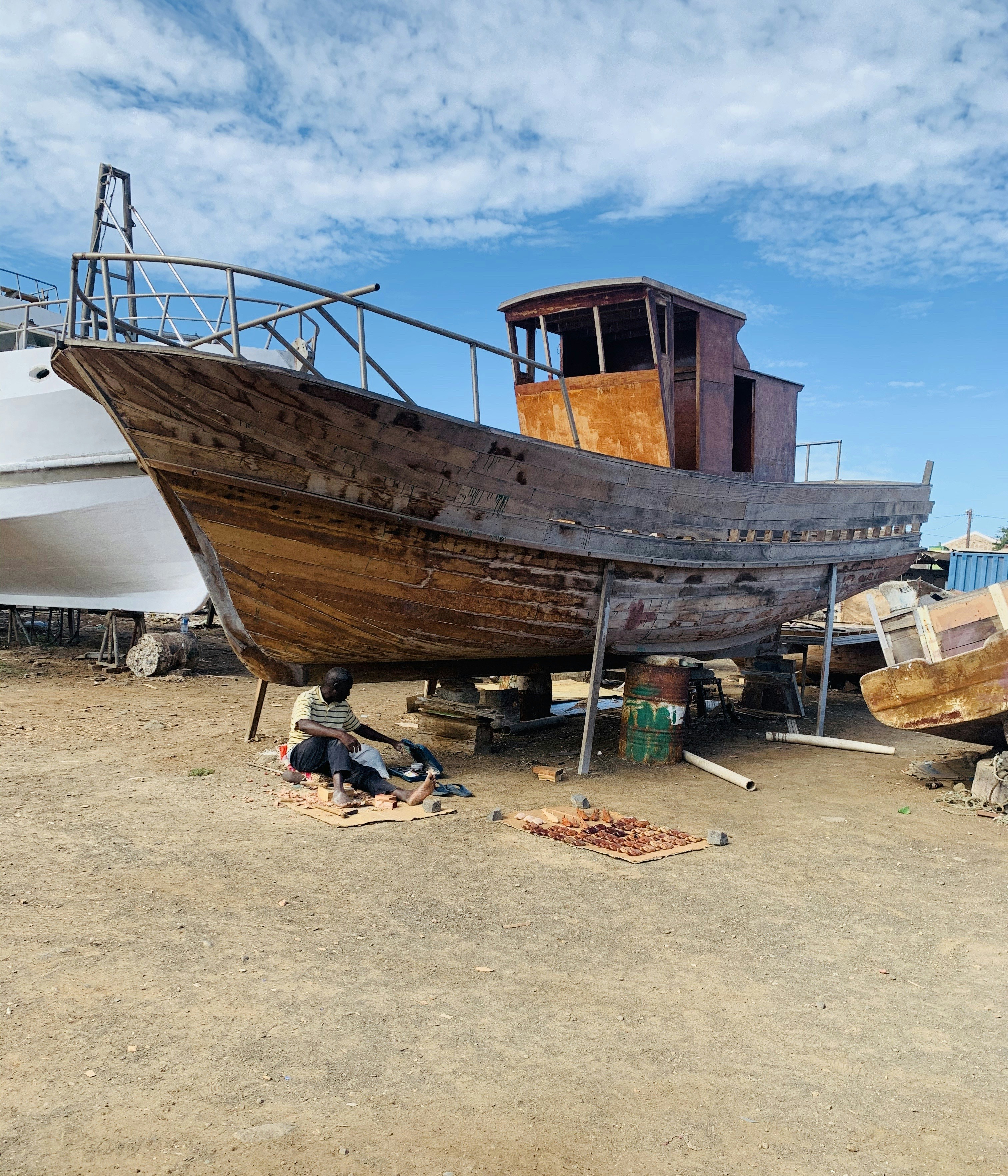 brown and white boat on brown sand during daytime