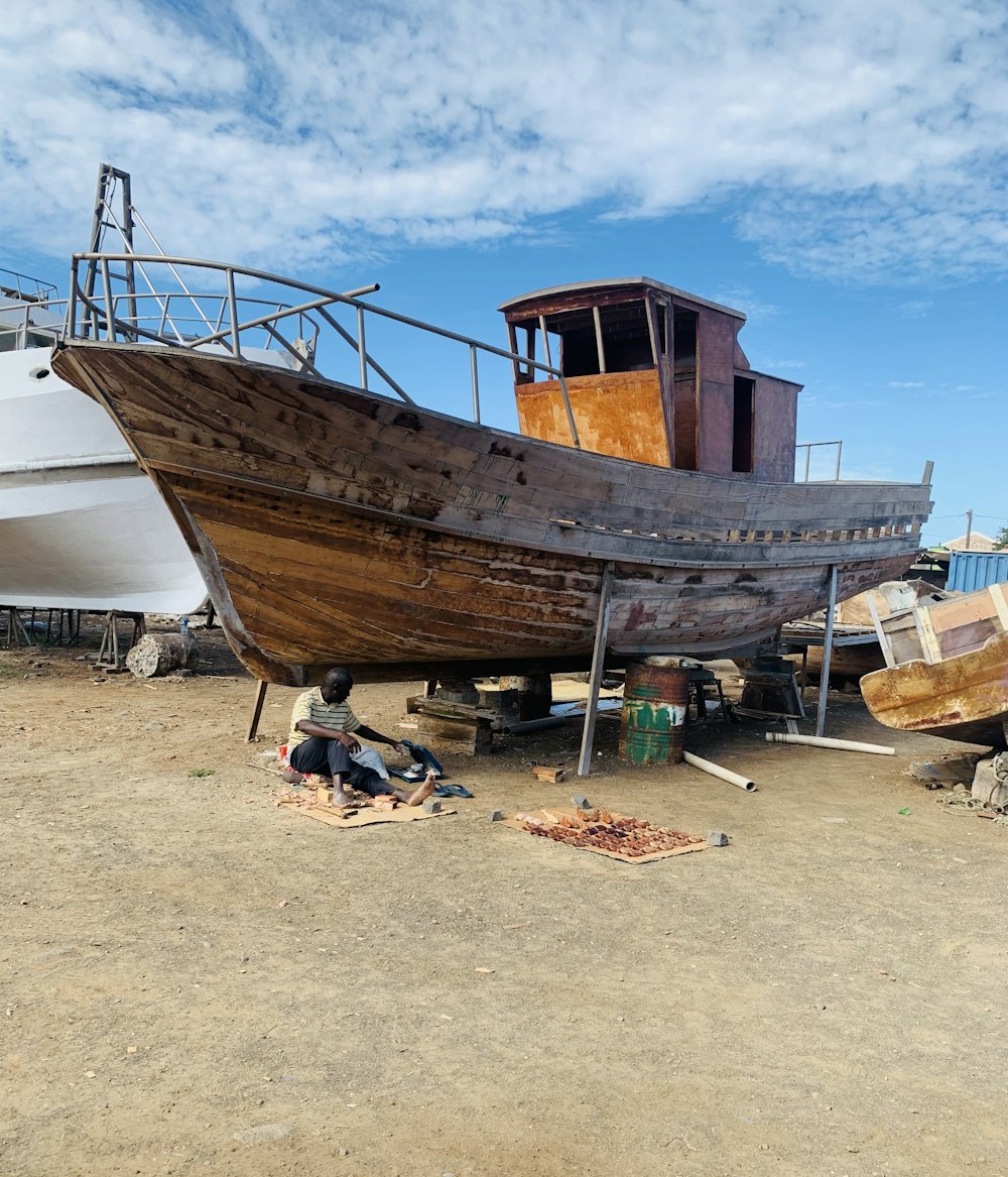 brown and white boat on brown sand during daytime