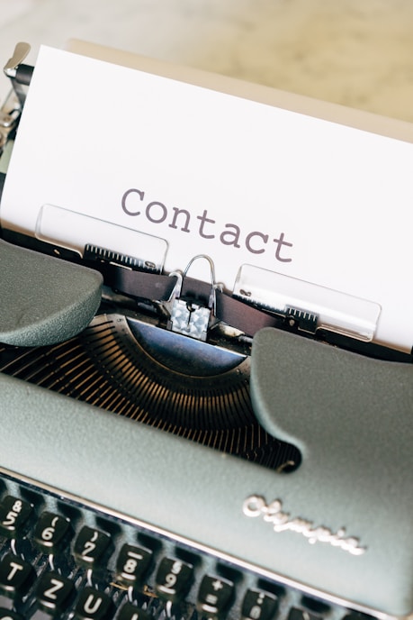 The word CONTACT typed on a blank sheet of paper
