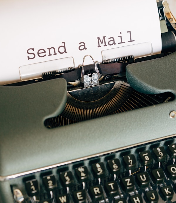 black and white typewriter with white printer paper