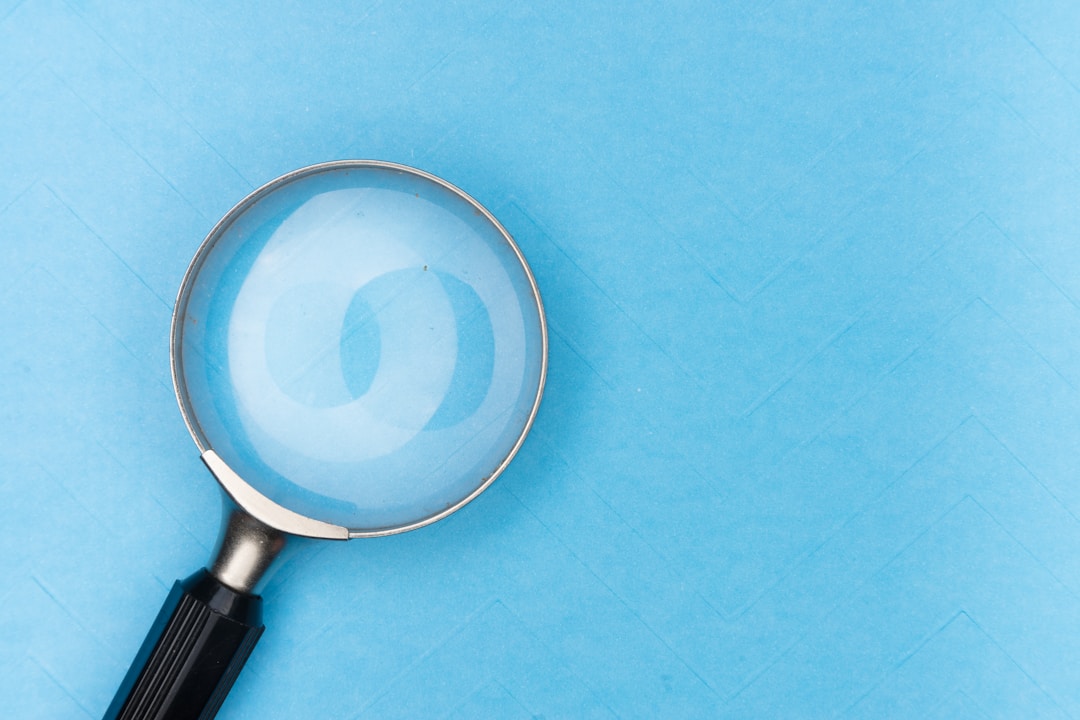 A looking glass sits on a blue textured table