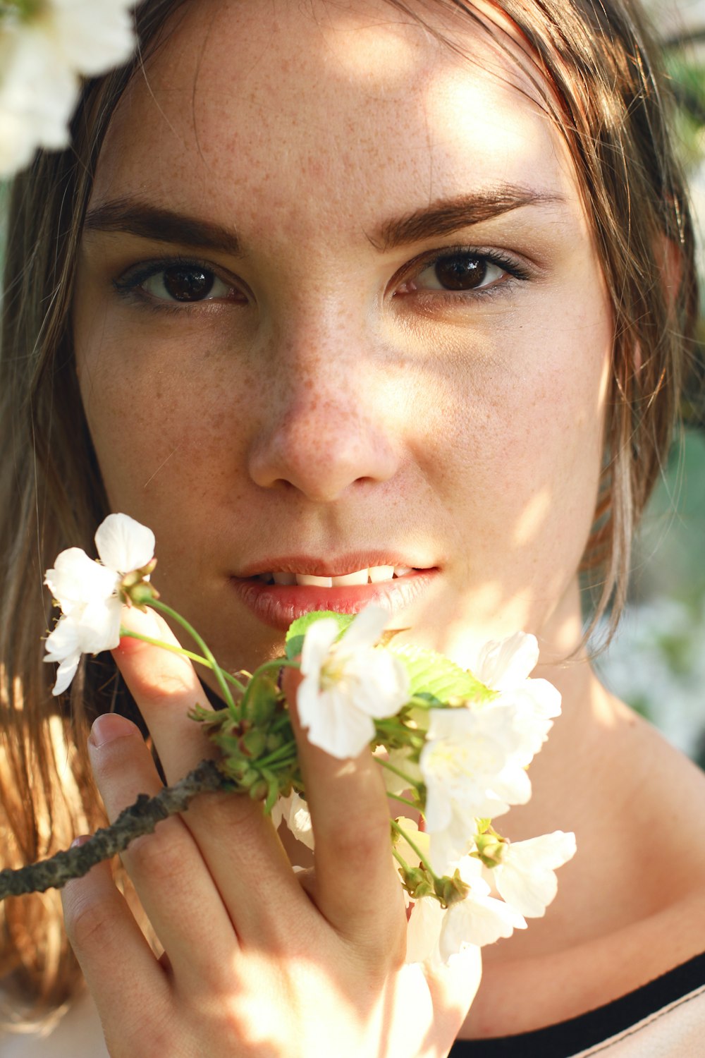 woman with white flower on her ear