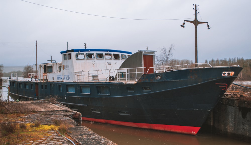 white and red ship on dock during daytime