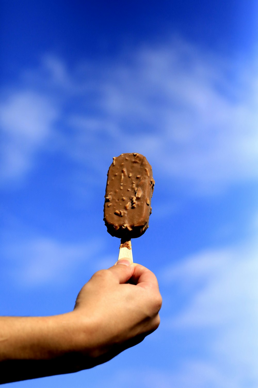 person holding chocolate ice cream