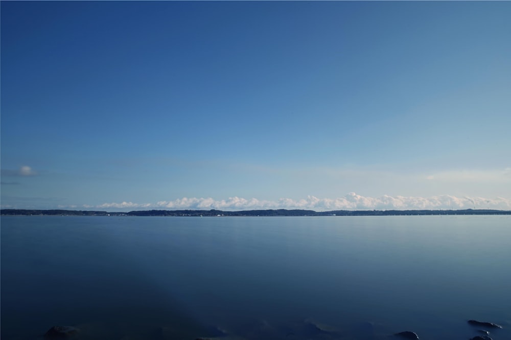 body of water under blue sky during daytime