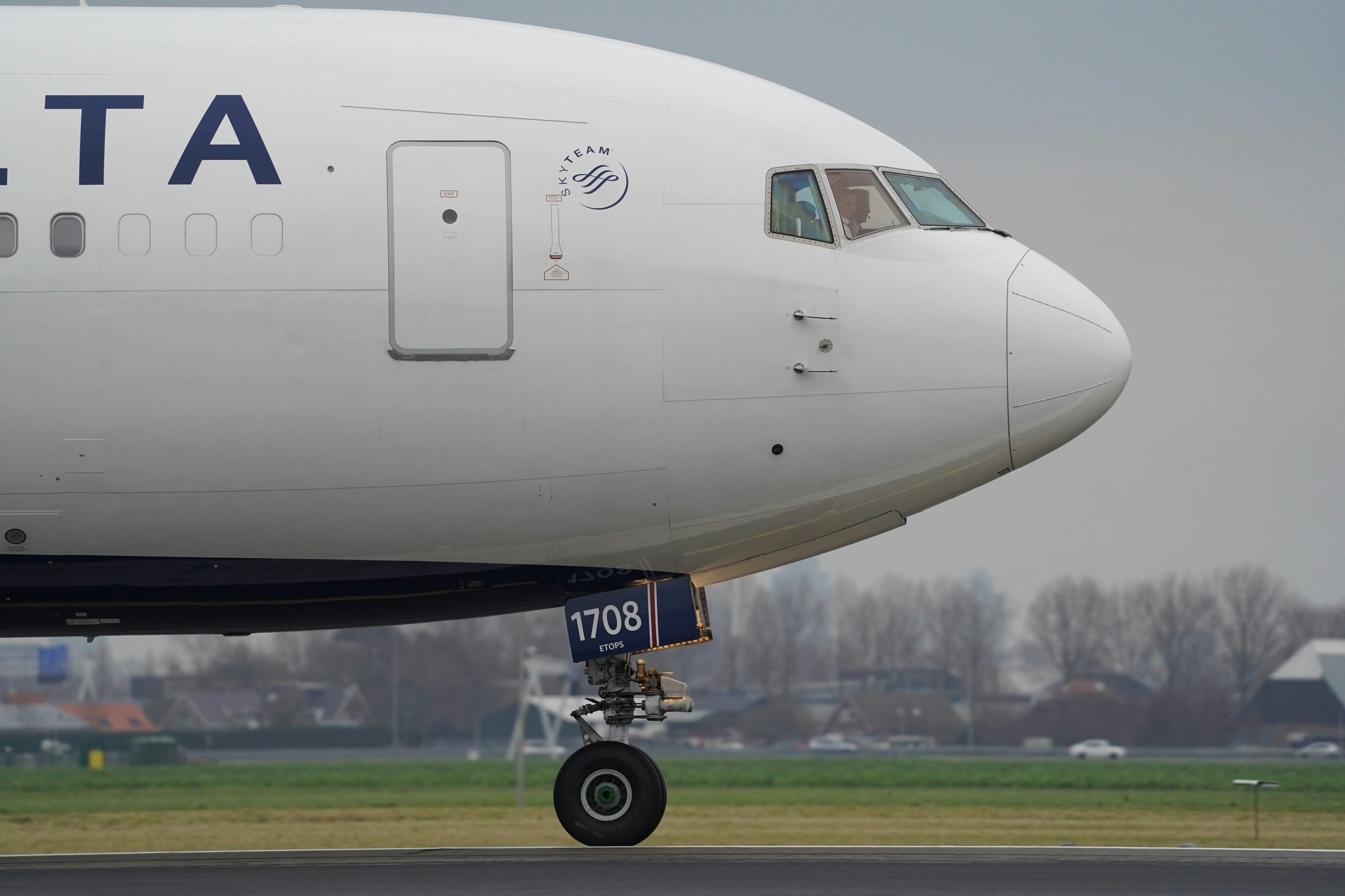 white passenger plane on airport during daytime, Delta 767 landing at Amsterdam Schiphol