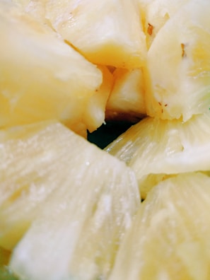 A close-up shot of fresh pineapple slices glistening with juice.