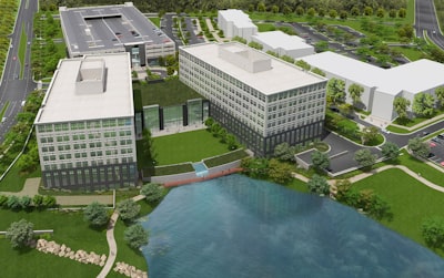 white concrete building near green trees and body of water during daytime