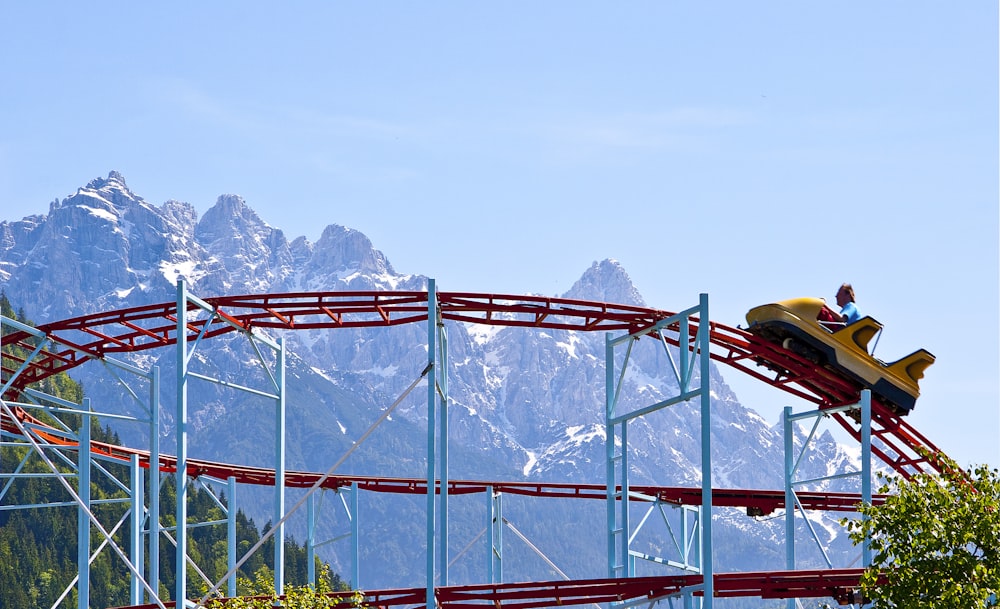 yellow and black car on red metal bridge during daytime