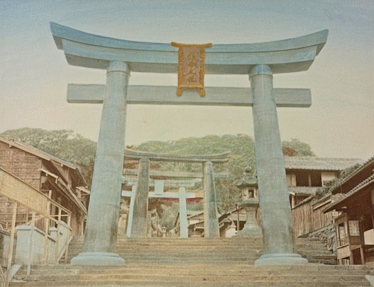 brown concrete cross on top of gray concrete pillar in Nagasaki Japan