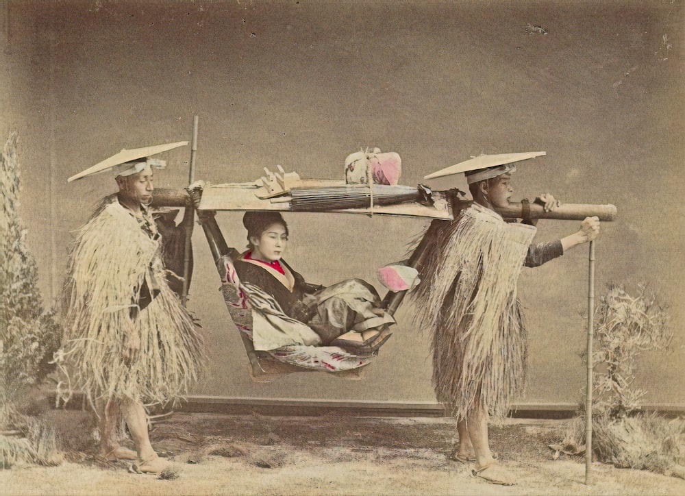 man in red and white shirt lying on brown sand