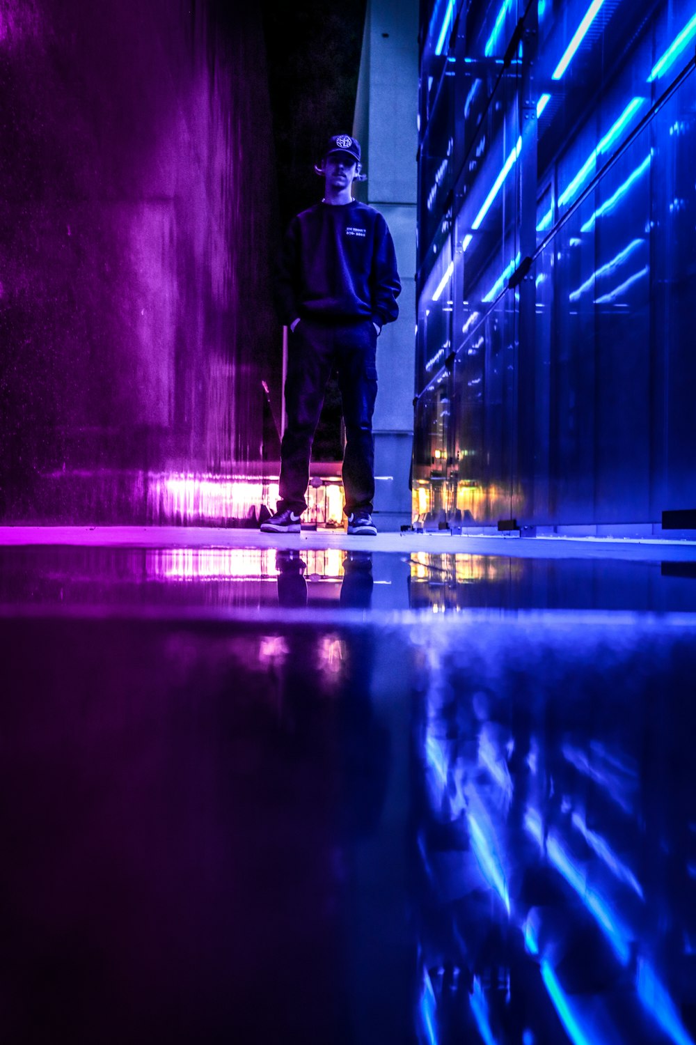 man in black jacket walking on tunnel