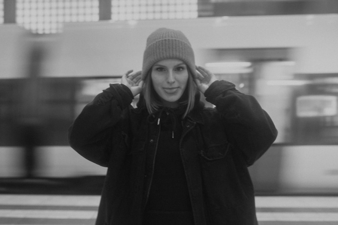 grayscale photo of woman in knit cap and jacket