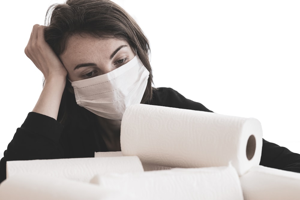 woman covering her face with white tissue paper