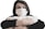 A person wearing a medical face mask is holding several rolls of toilet paper. The individual has dark hair and gazes directly at the camera. The background is plain and light-colored, highlighting the focus on the person and the items they are holding.