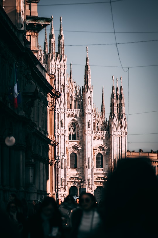 people walking on street near building during daytime in Duomo di Milano Italy
