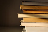 Stack of colorful books arranged neatly with soft natural light