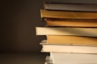A stack of popular novels with a warm light.