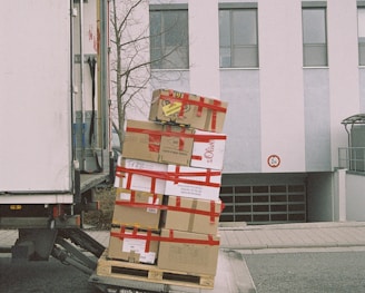 brown cardboard boxes on gray asphalt road