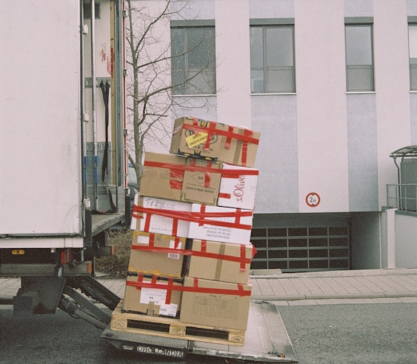 brown cardboard boxes on gray asphalt road