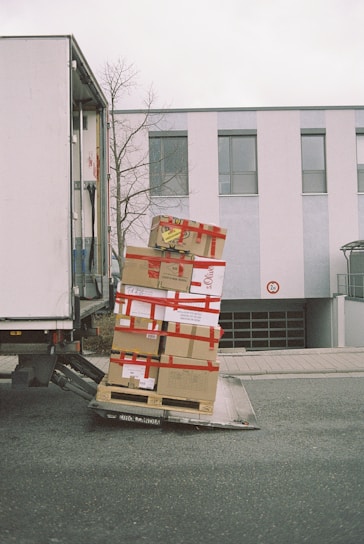 brown cardboard boxes on gray asphalt road