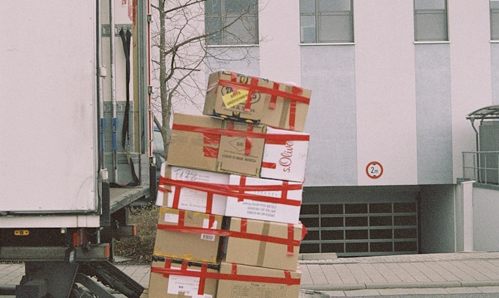 brown cardboard boxes on gray asphalt road