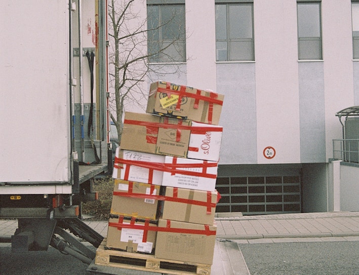 brown cardboard boxes on gray asphalt road