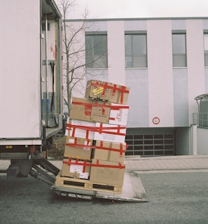 brown cardboard boxes on gray asphalt road