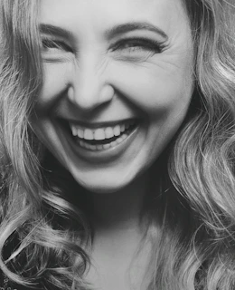 A vibrant, candid portrait of a person laughing, full of personality and life.
