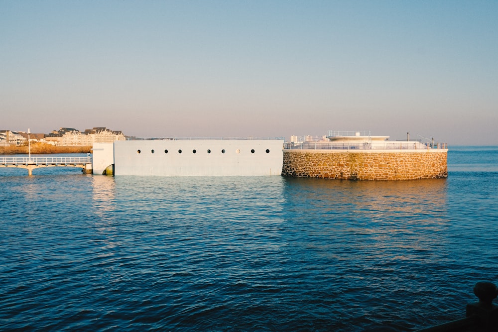 white concrete building near body of water during daytime