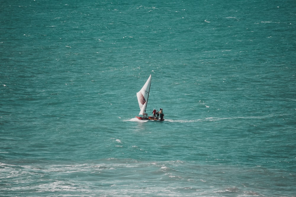 person in black wet suit surfing on sea during daytime