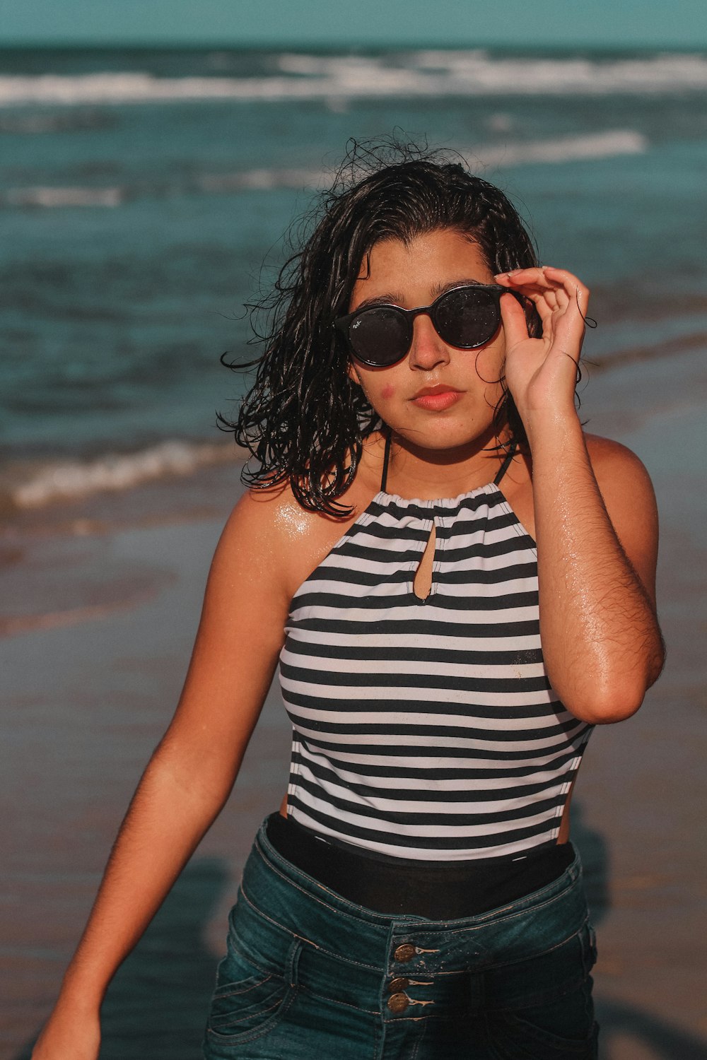 woman in black and white stripe tank top and black sunglasses