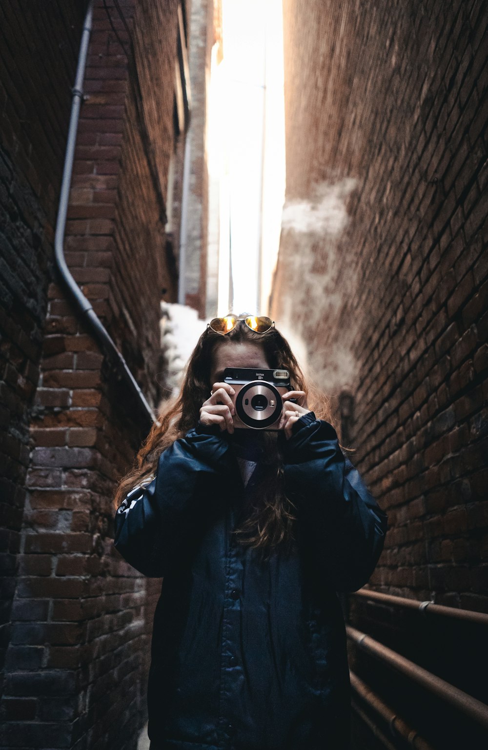 woman in black leather jacket wearing black and gold mask