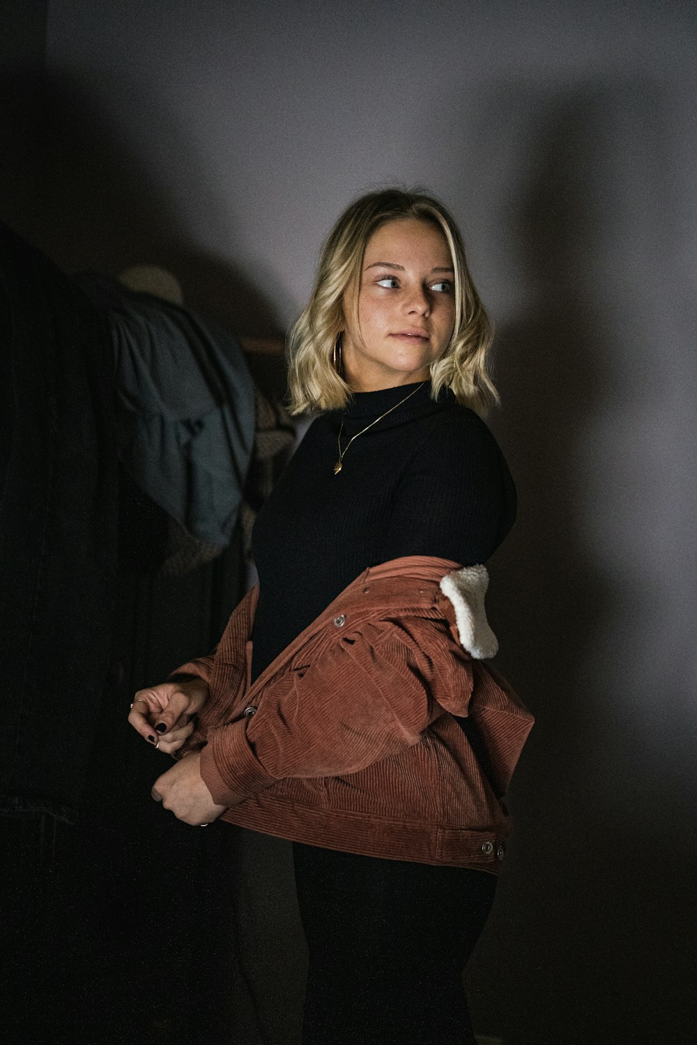 woman in black long sleeve shirt and brown skirt